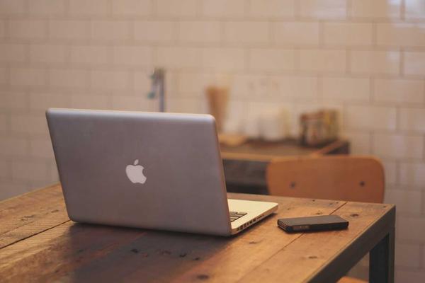 Minimalist tech hardware neatly arranged on a clean white desk surface, symbolizing structured secure corporate technology, no human figures